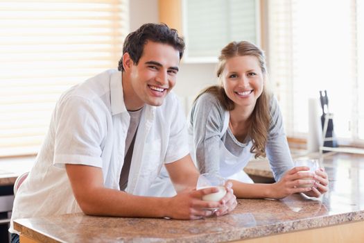 Smiling young couple with glasses of milk
