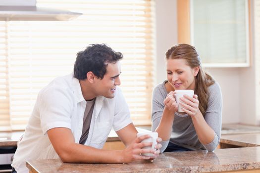 Young couple enjoying tea in the kitchen