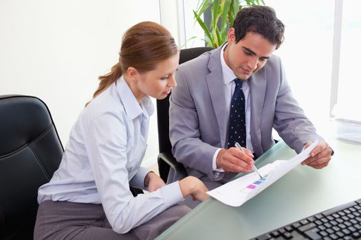 Young colleagues analyzing statistics together