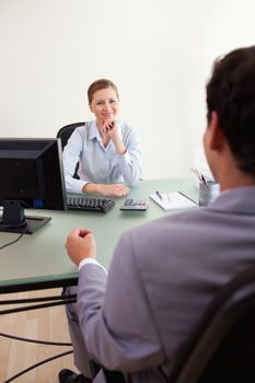 Young businesswoman listening to client