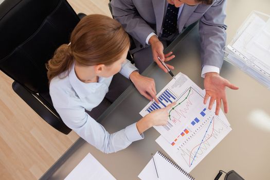 Above view of young business people analyzing statistics