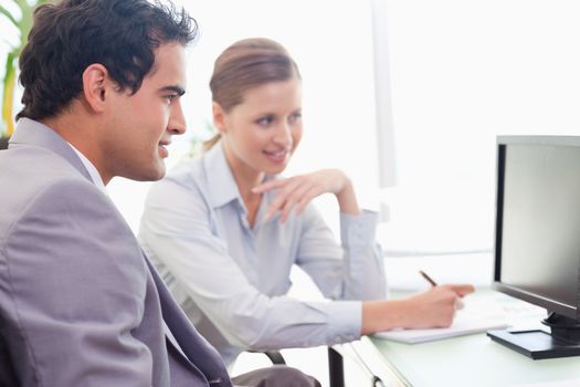 Young mentor explains work to his new colleague