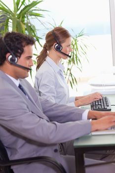 Young call center agents working next to each other