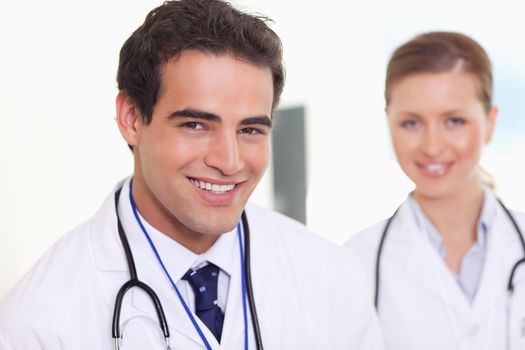 Smiling young assistant doctors standing next to each other