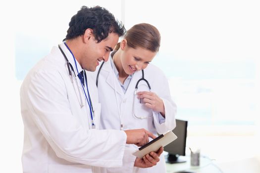 Young medical assistants looking at clip board