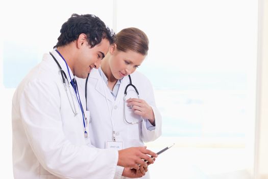 Young medical staff looking at clip board