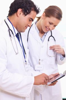 Young assistant doctors using tablet together