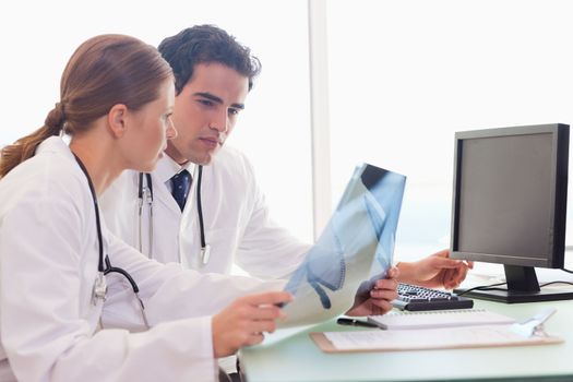 Young medical team checking x-rays