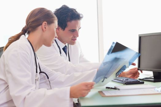 Young medical team analyzing x-rays