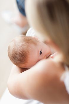 Above view of small baby getting breastfed