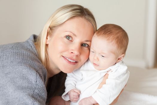 Young mother holding her newborn close