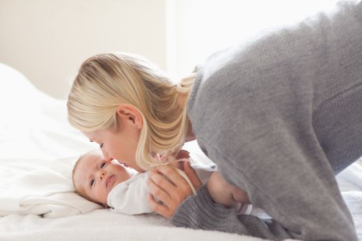 Young mom cuddling with her baby