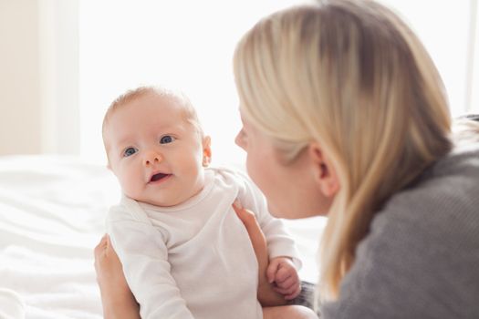 Young mother holding newborn