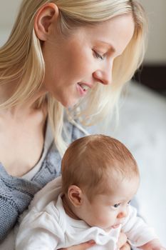Young mother hugging her baby