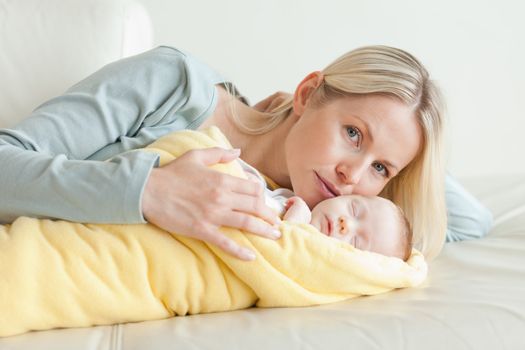 Young mom relaxing next to her baby