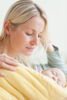 Young mother resting next to her sleeping baby