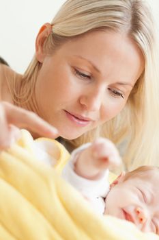 Close up of young mother relaxing next to her sleeping baby