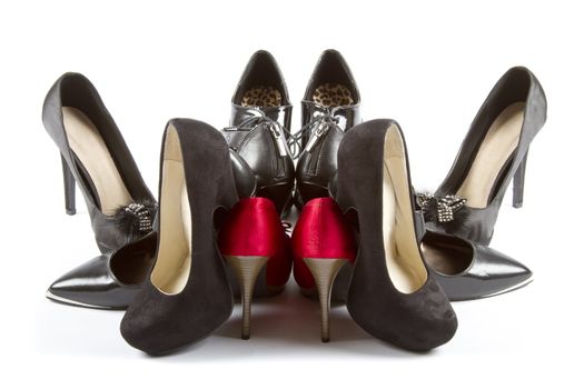 Several pairs of high heels in red and black