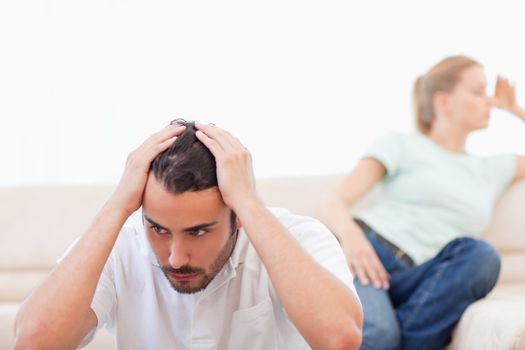 Upset couple mad at each other in their living room