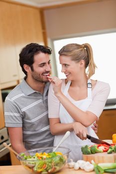 Portrait of a lovely couple cooking in their kitchen