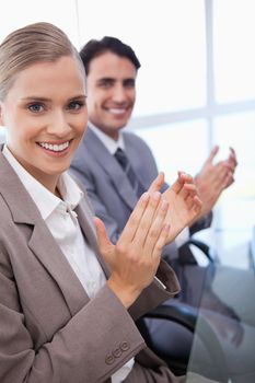 Portrait of a business team applauding in a meeting room