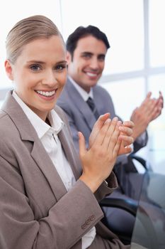 Portrait of a smiling business team applauding in a meeting room