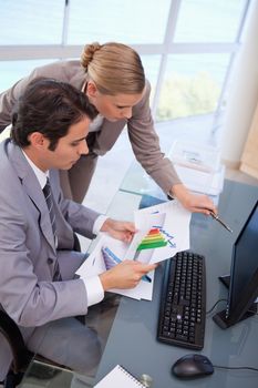 Portrait of a focused business team looking at a graph in an office