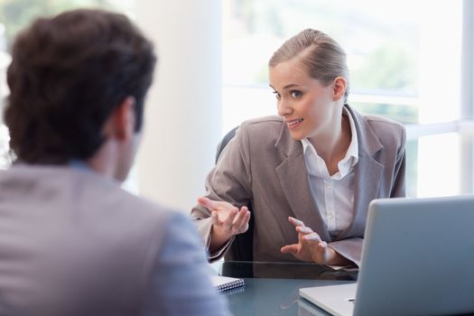 Cute businesswoman receiving a customer in her office