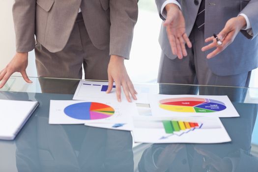 Hands of business people working on statistics in a meeting room