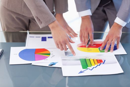 Hands of business people studying statistics in a meeting room