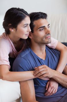 Portrait of a young couple posing in their living room