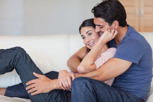 In love couple cuddling each other in their living room