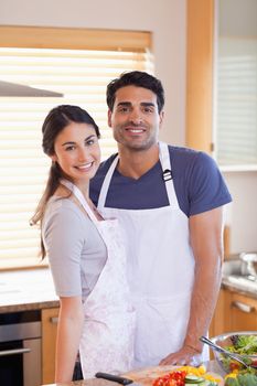 Portrait a couple posing in their kitchen