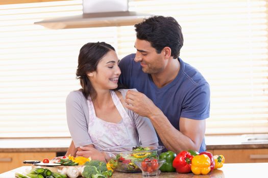 Man feeding his girlfriend in their kitchen