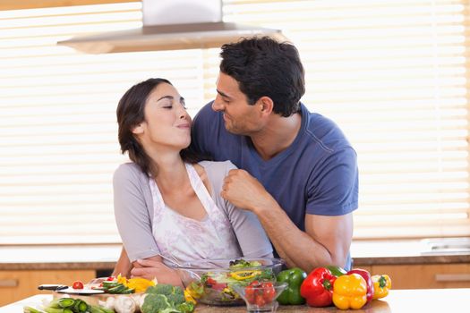 Man feeding his fiance in their kitchen