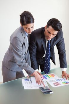 Portrait of focused sales persons studying their results in an office