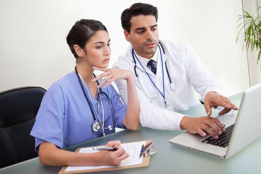 Young doctors working with a notebook in an office