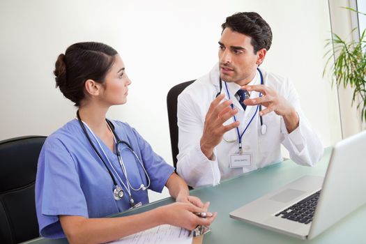 Young doctors working with a laptop in an office