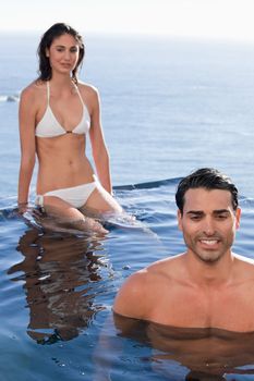 Portrait of a couple relaxing in a swimming pool