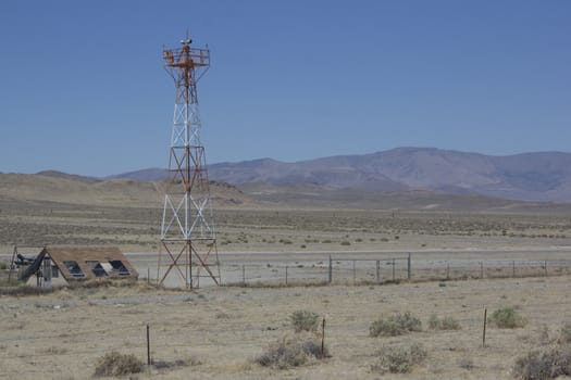 runway in the middle of the desert with a radar