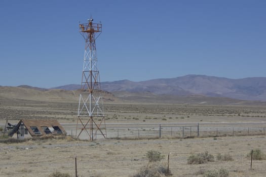 runway in the middle of the desert with a radar