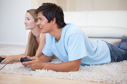 Couple playing video games in their living room