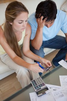 Portrait of a couple cutting their credit card in their living room