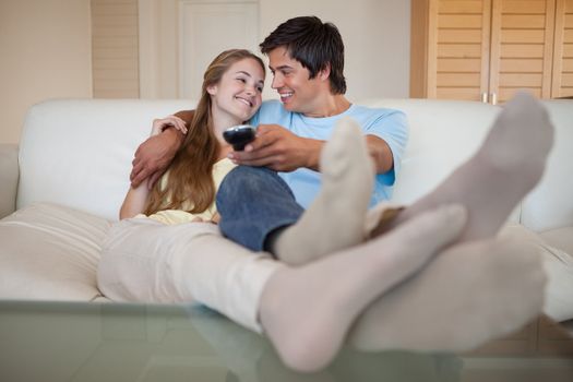 In love couple watching television in their living room
