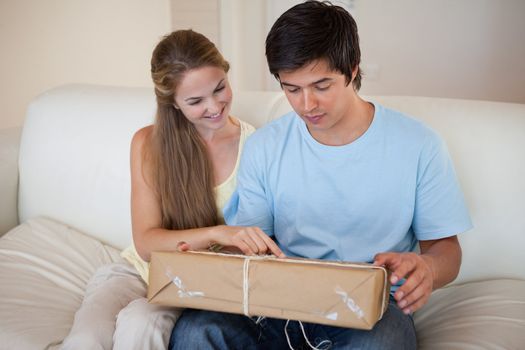 Couple looking at a package in their living room