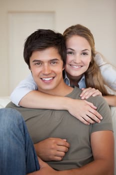 Portrait of a couple hugging in their living room