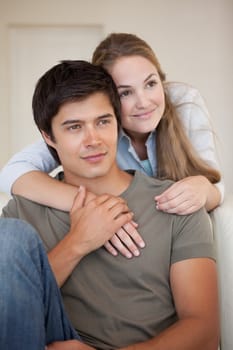 Portrait of a couple embracing in their living room
