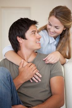 Portrait of a young couple hugging in their living room