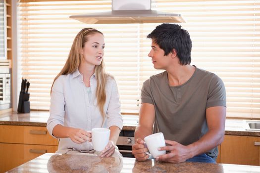 Couple having a cup of coffee in their kitchen