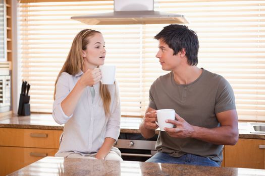 Couple having a cup of tea in their kitchen